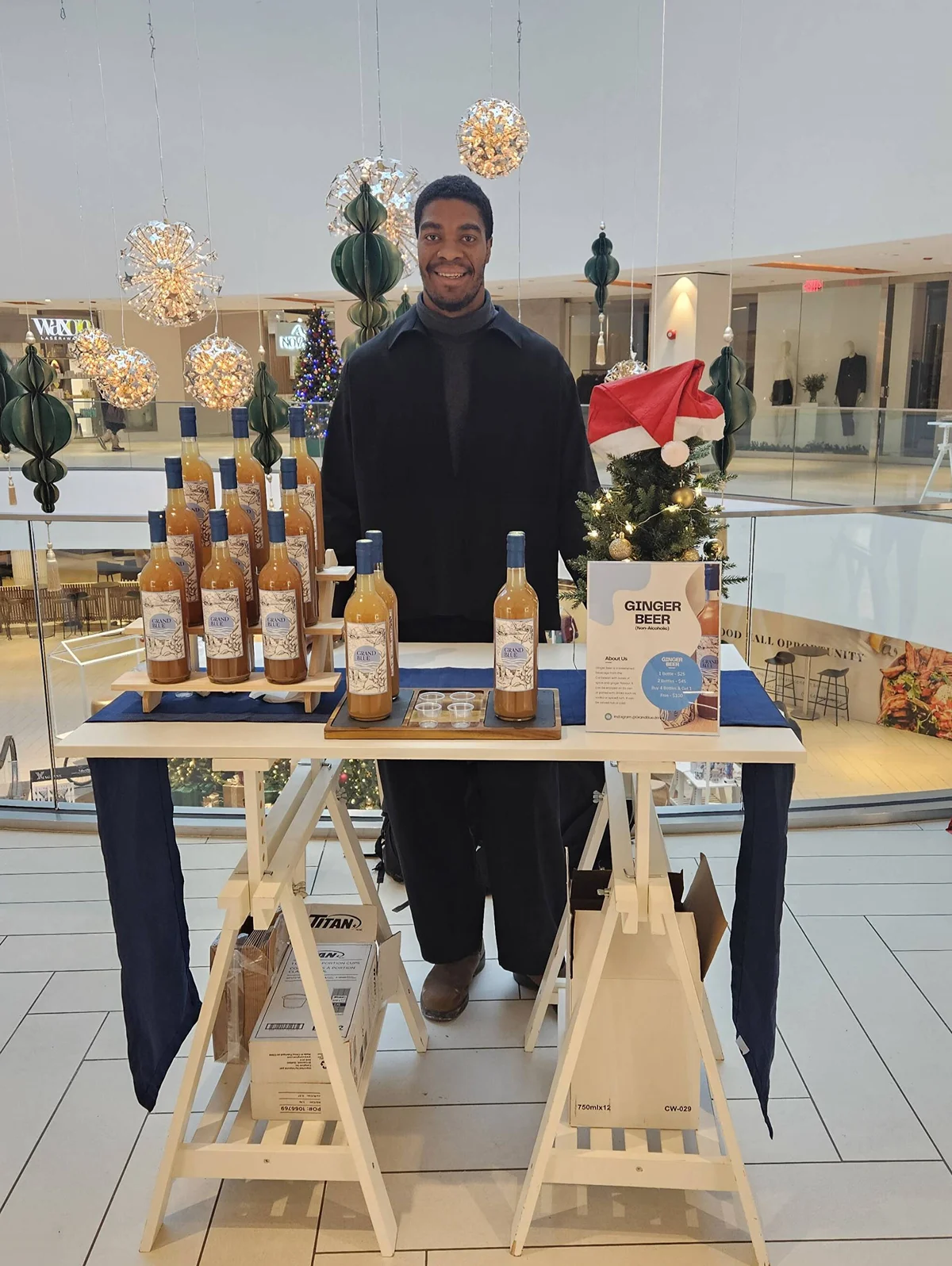 Grand Blue founder pouring ginger beer at a Toronto Christmas market